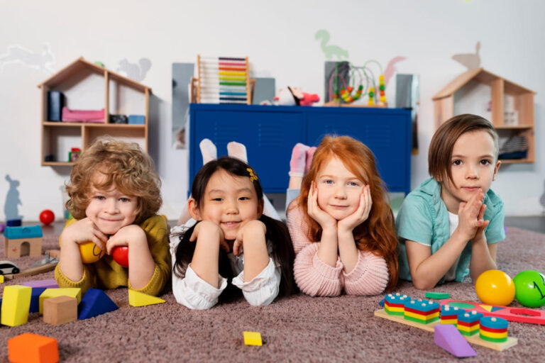full-shot-kids-sitting-together-kindergarten (1)